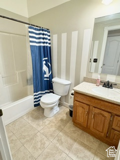 Full bath with toilet, shower / tub combo, tile patterned flooring, and vanity
