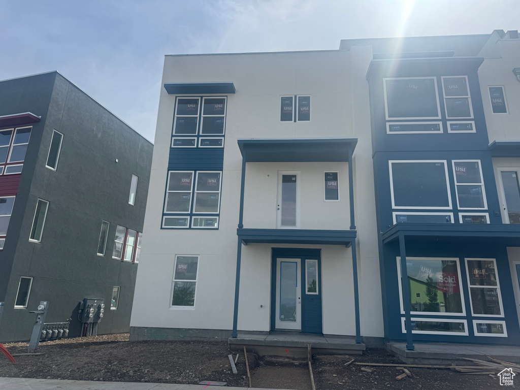 View of front of house featuring stucco siding