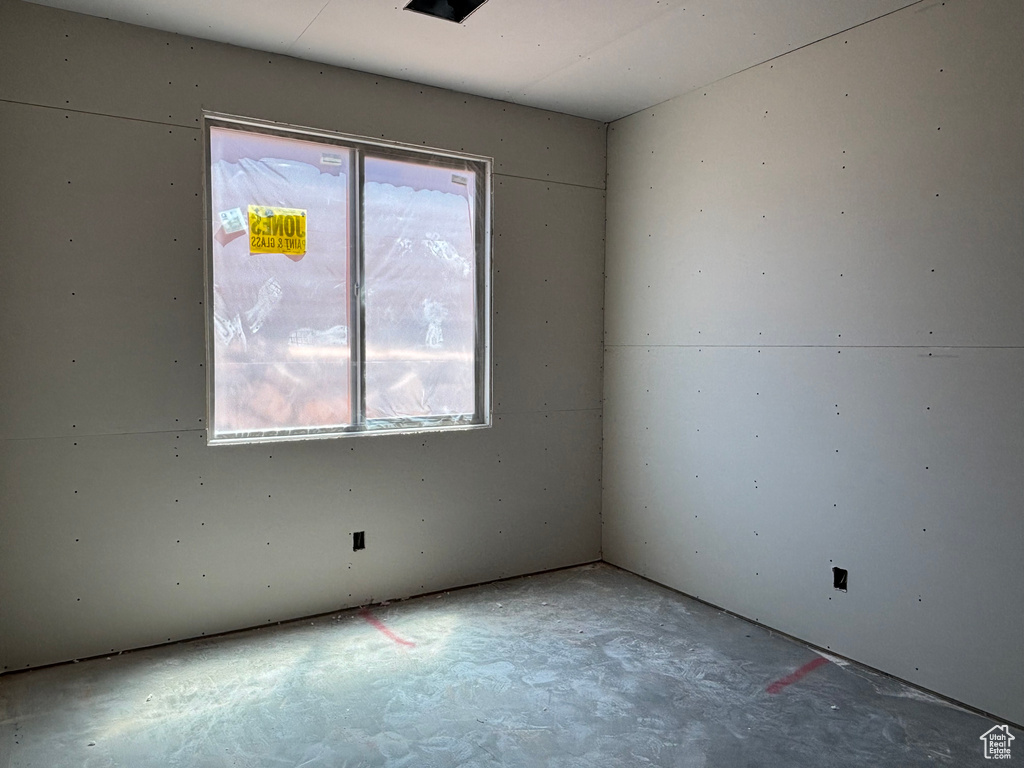 Empty room with unfinished concrete flooring