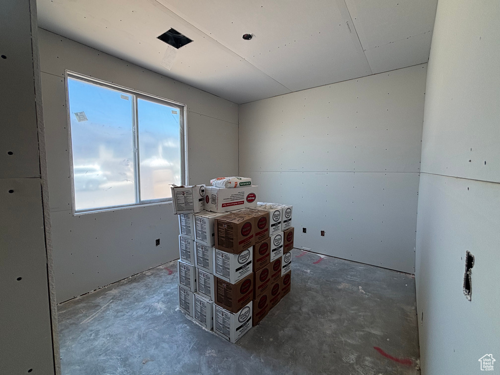Bedroom featuring concrete flooring