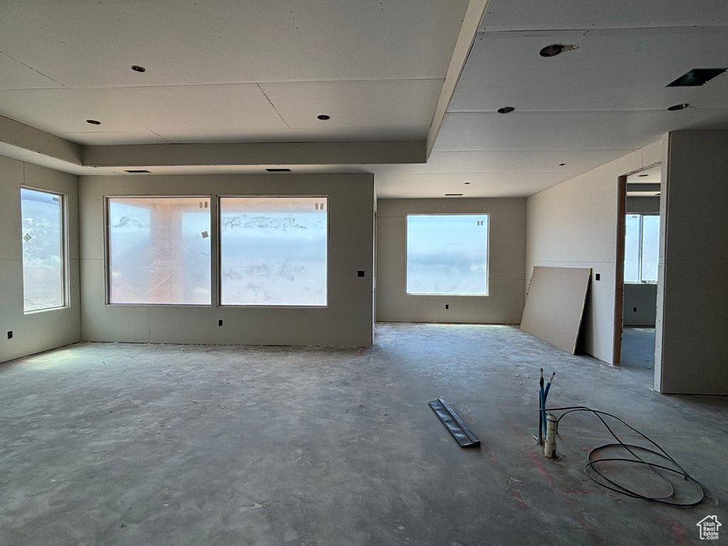 Empty room featuring unfinished concrete flooring
