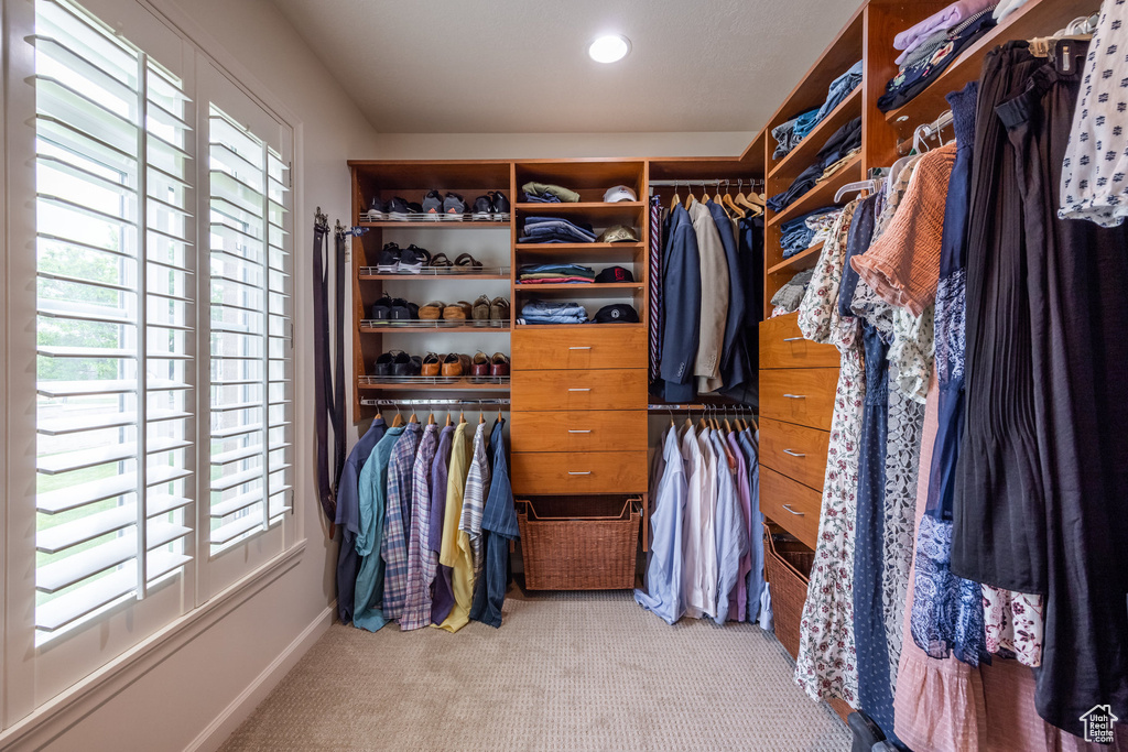 Walk in closet with light carpet