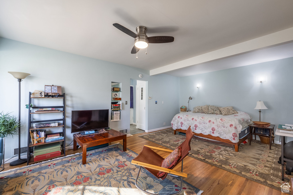 Bedroom with wood finished floors, baseboards, and ceiling fan