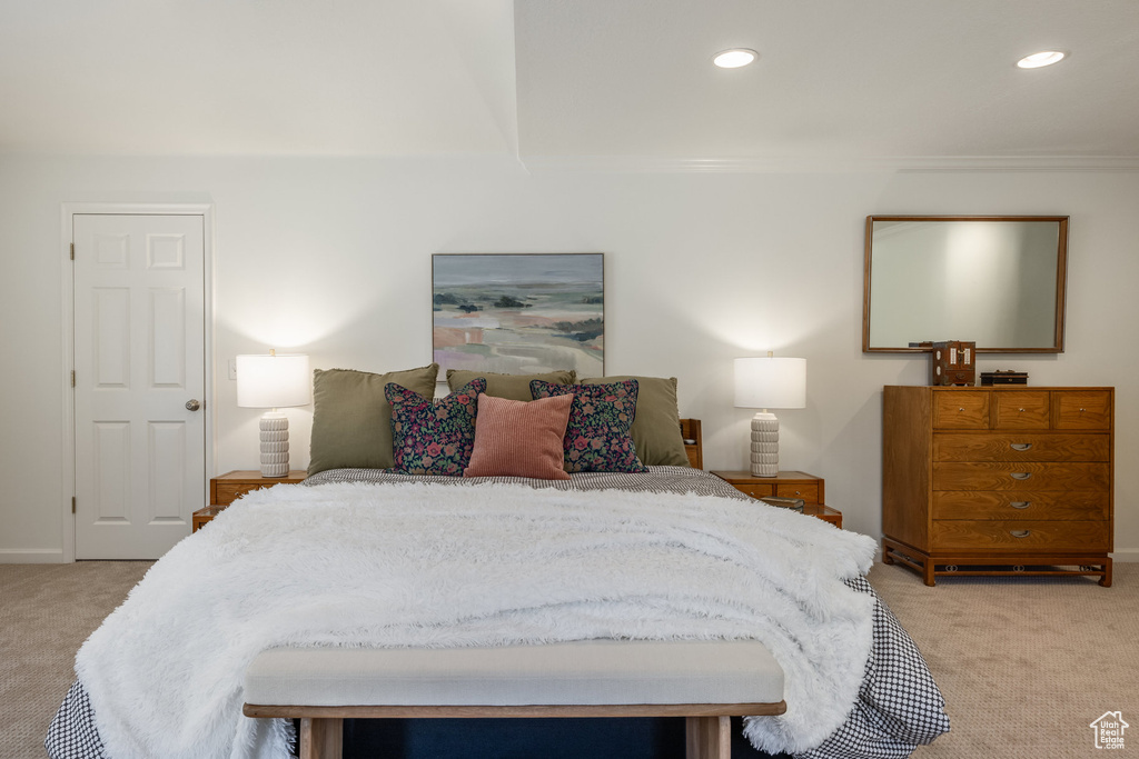 Bedroom with light colored carpet, recessed lighting, and baseboards