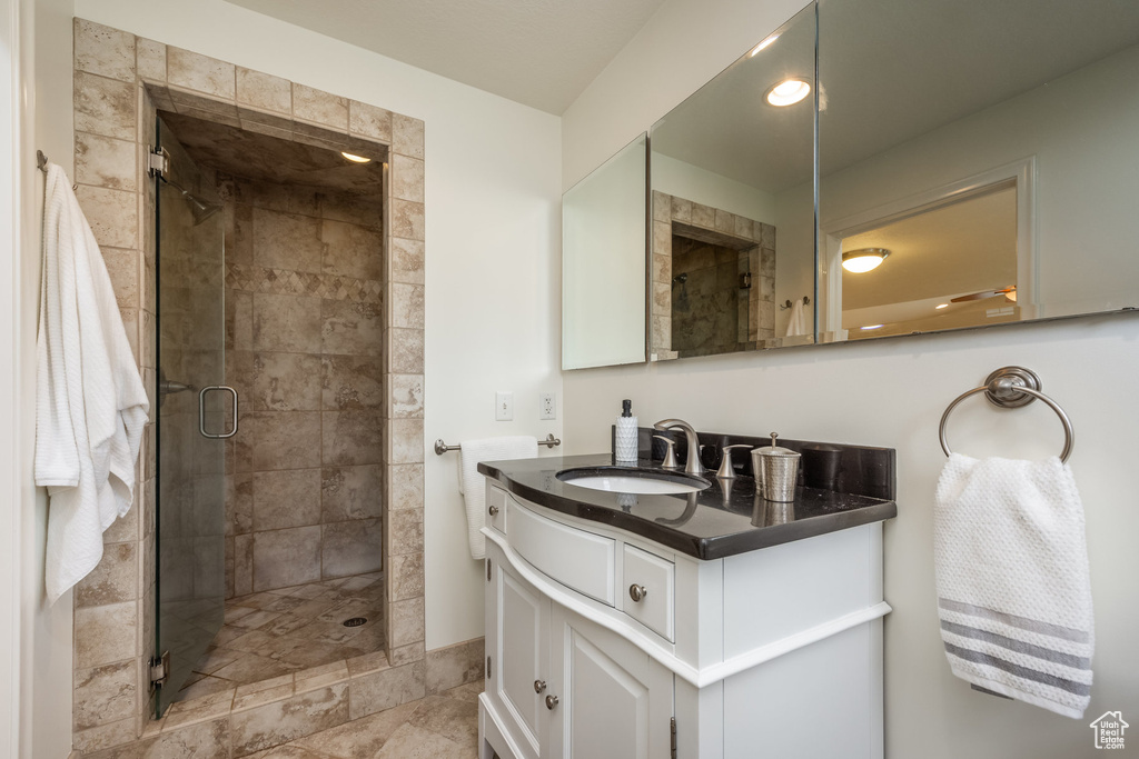 Bathroom with a shower stall and vanity