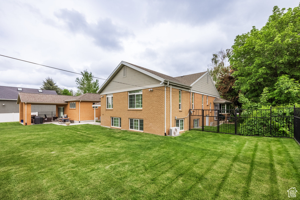 Rear view of property with brick siding and a patio area