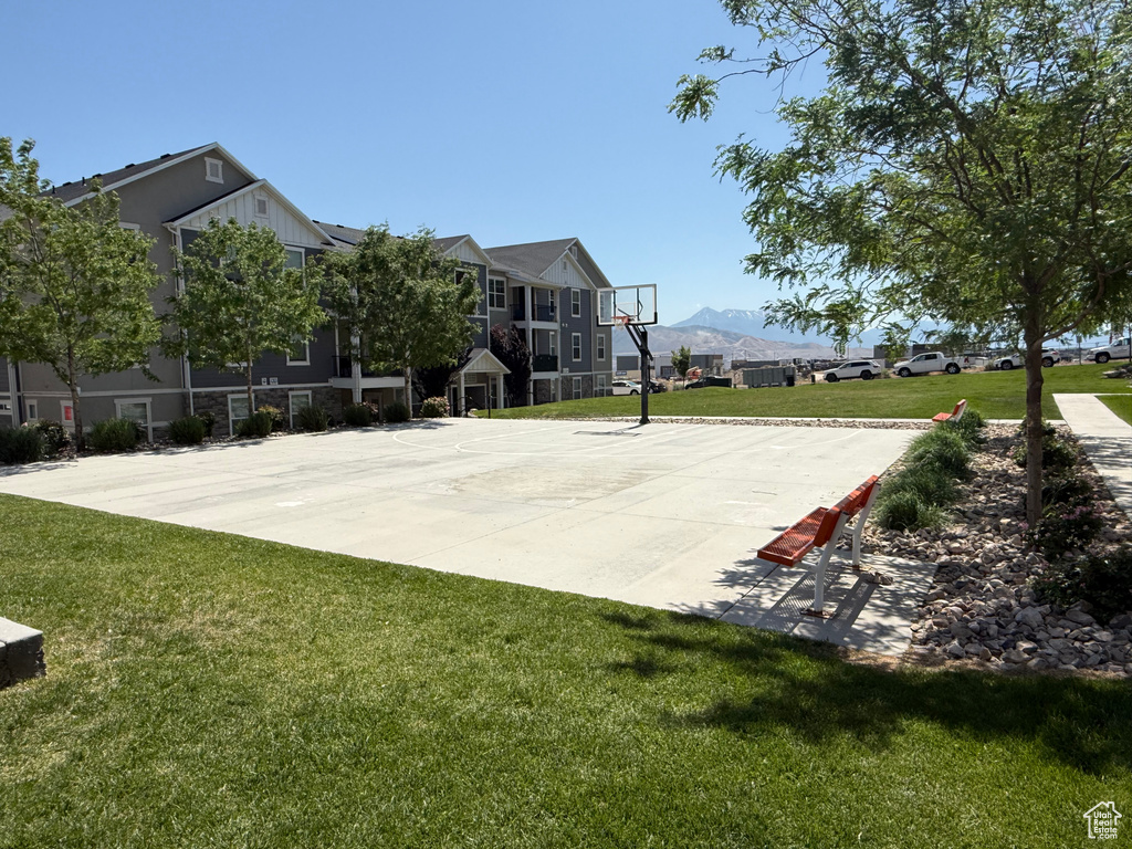 View of basketball court with community basketball court, a lawn, and a mountain view
