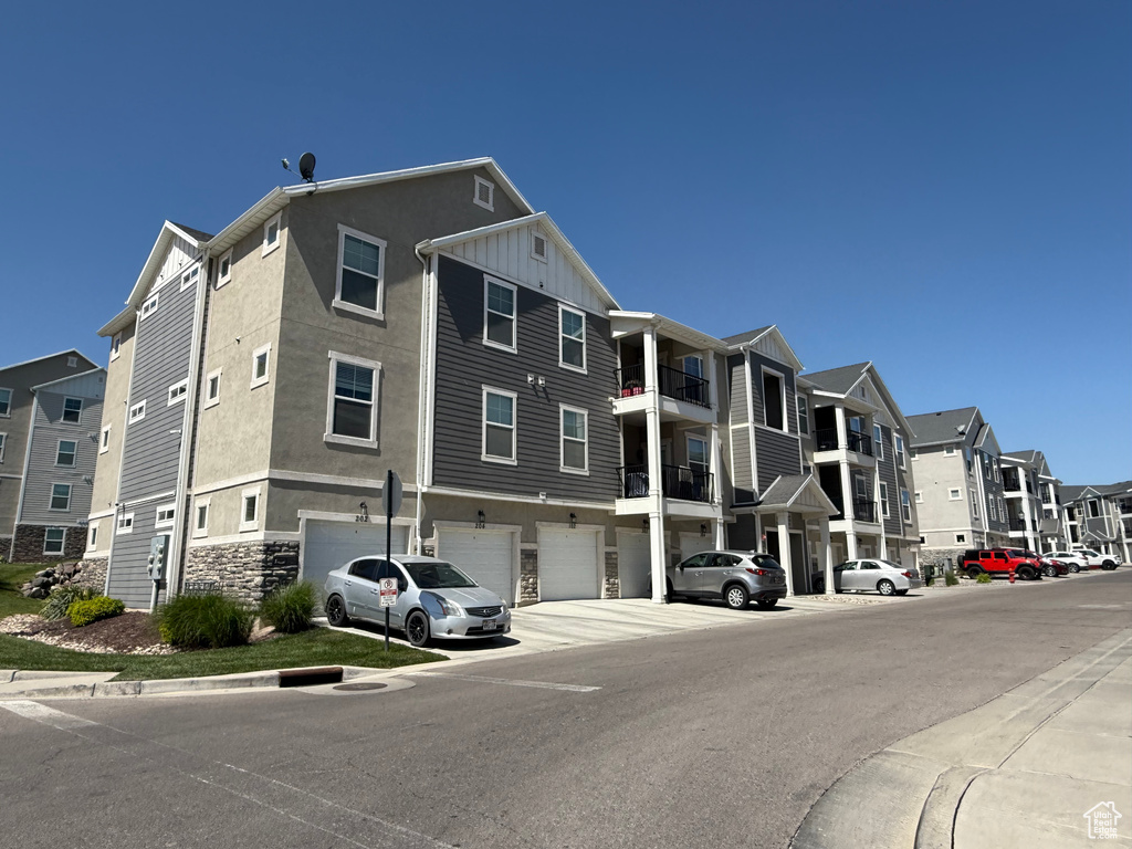 View of property with a garage and a residential view