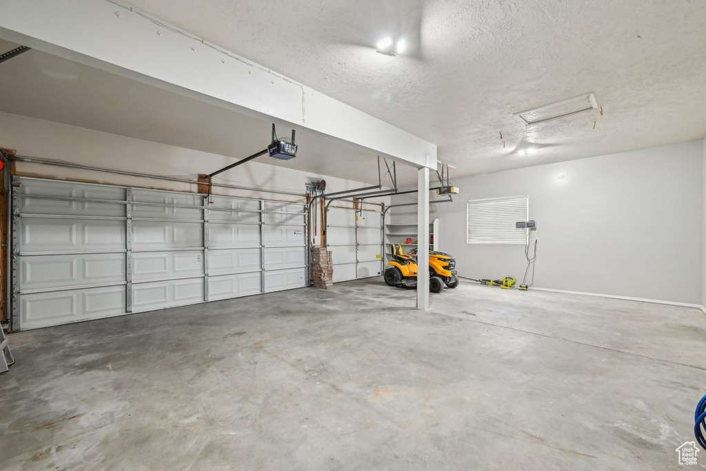 Garage featuring a garage door opener