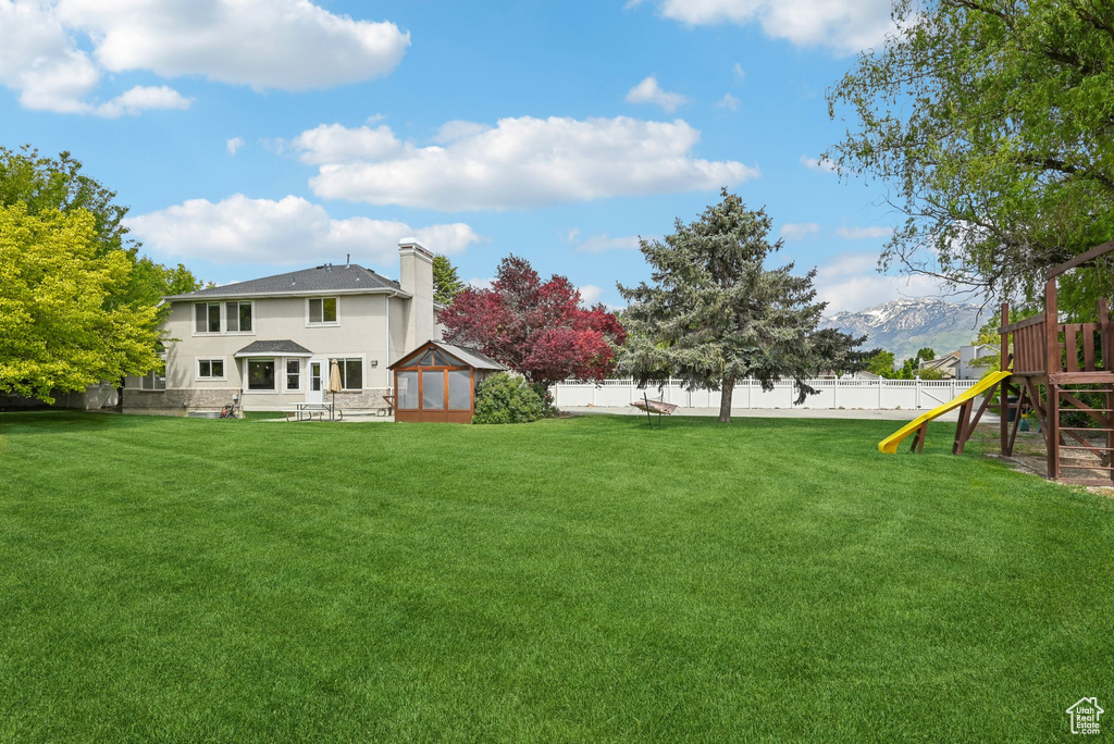 View of yard featuring a playground