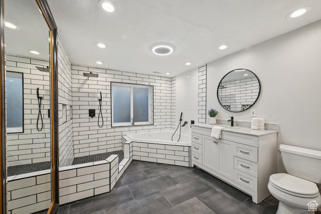 Full bath with a bath, recessed lighting, vanity, a stall shower, and toilet