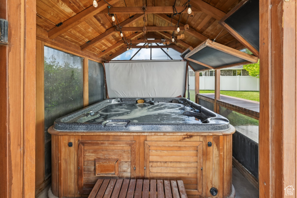 Sunroom featuring a hot tub and plenty of natural light