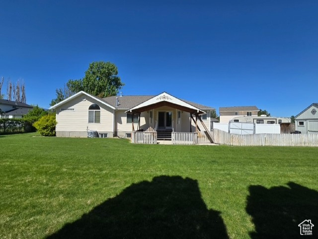 Rear view of property with covered porch