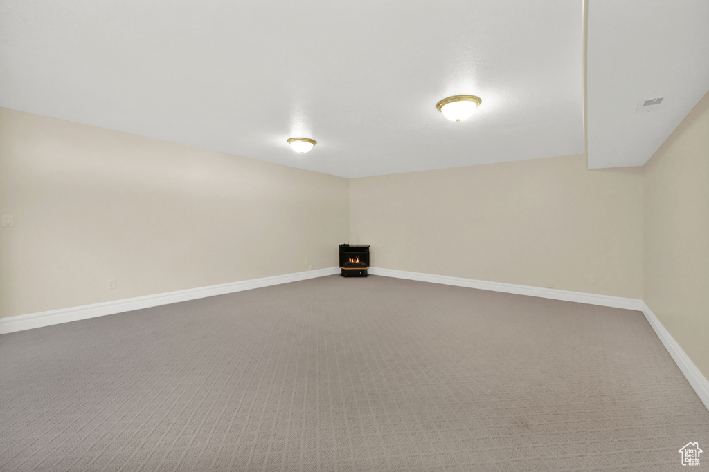 Spare room featuring carpet floors and baseboards
