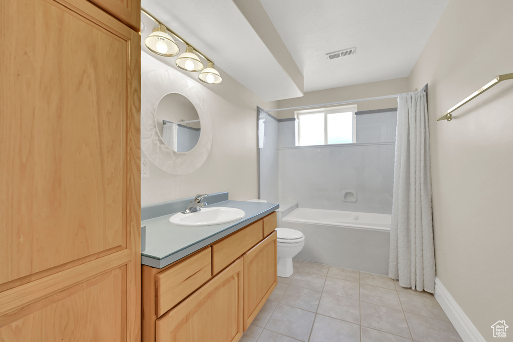 Full bath featuring toilet, vanity, visible vents, tile patterned floors, and shower / bath combination with curtain
