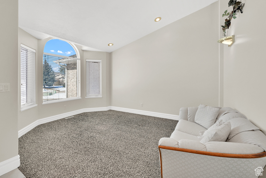 Sitting room featuring lofted ceiling, baseboards, carpet flooring, and recessed lighting