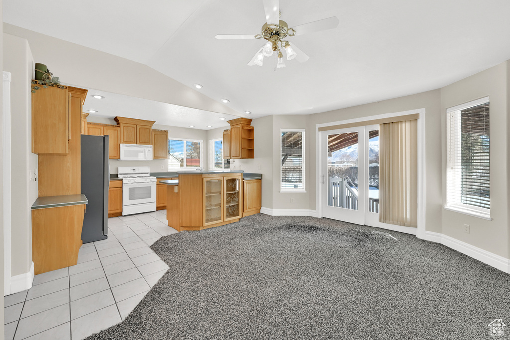 Kitchen featuring white appliances, light tile patterned floors, lofted ceiling, open shelves, and recessed lighting