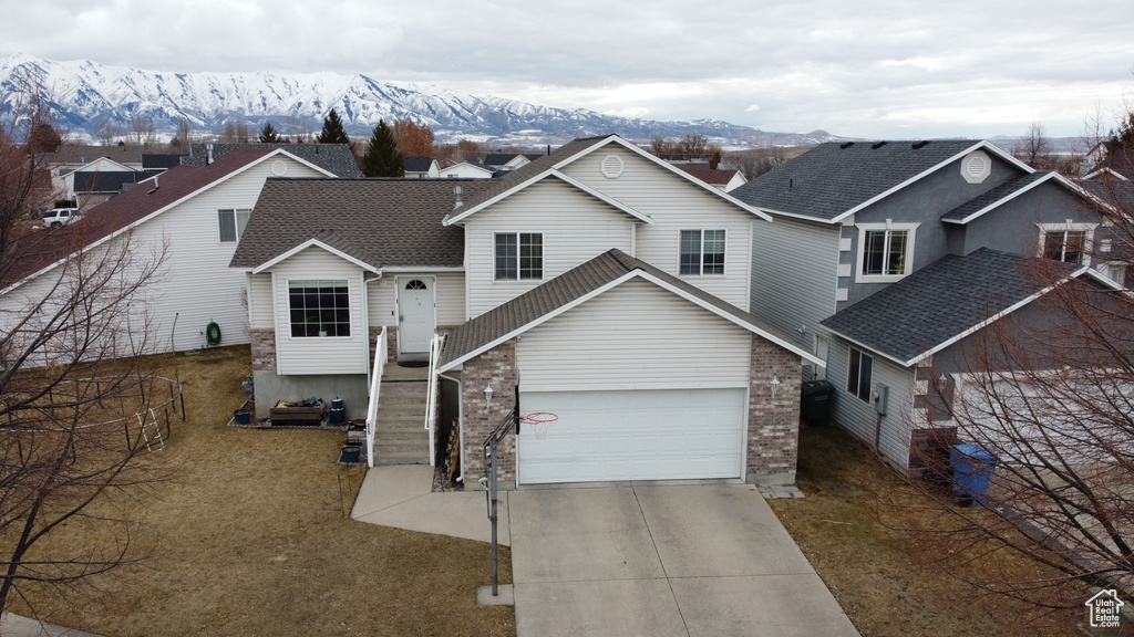 Traditional-style home featuring concrete driveway, brick siding, and a mountain view