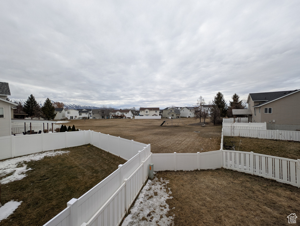 View of yard featuring a fenced backyard and a residential view