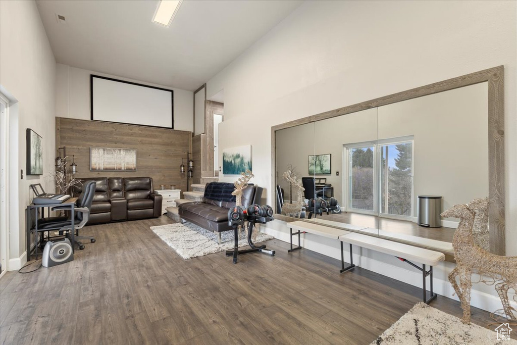 Living area with a towering ceiling and wood finished floors