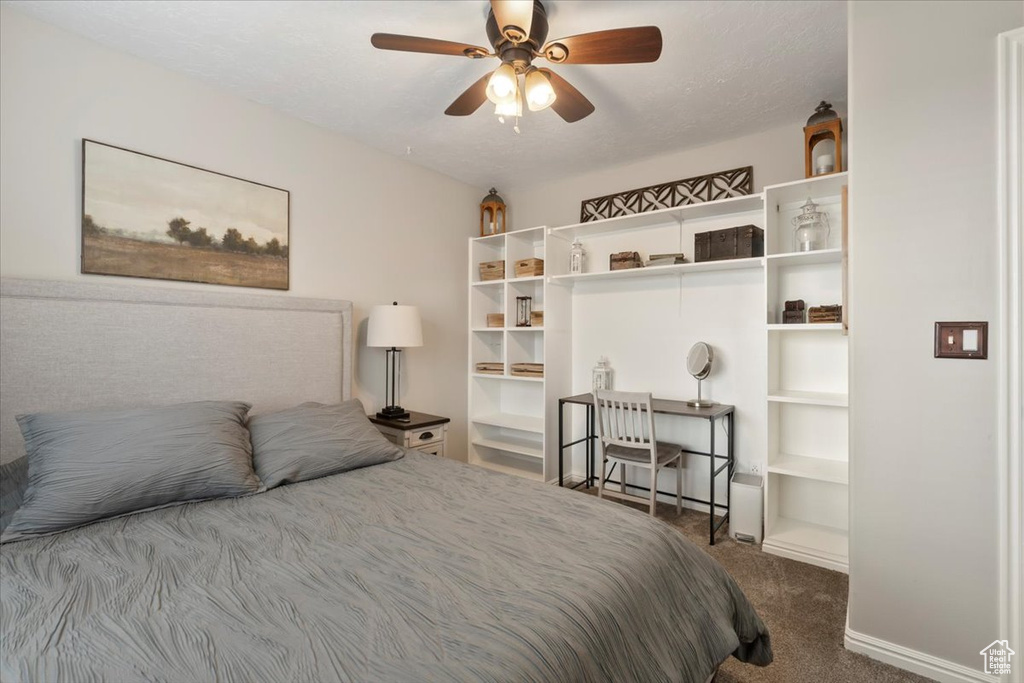 Bedroom with ceiling fan and carpet flooring