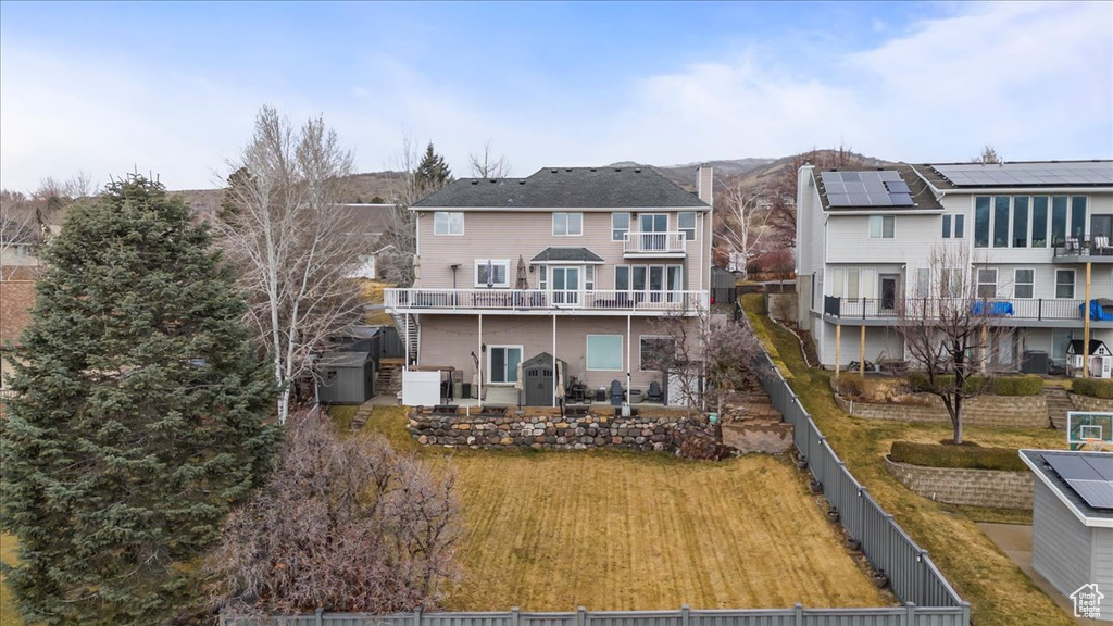 Rear view of house featuring cooling unit, a fenced backyard, and a residential view