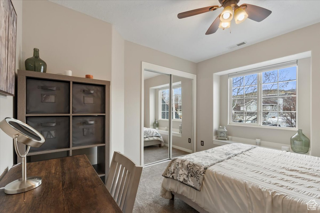 Bedroom with carpet floors, a closet, visible vents, ceiling fan, and baseboards