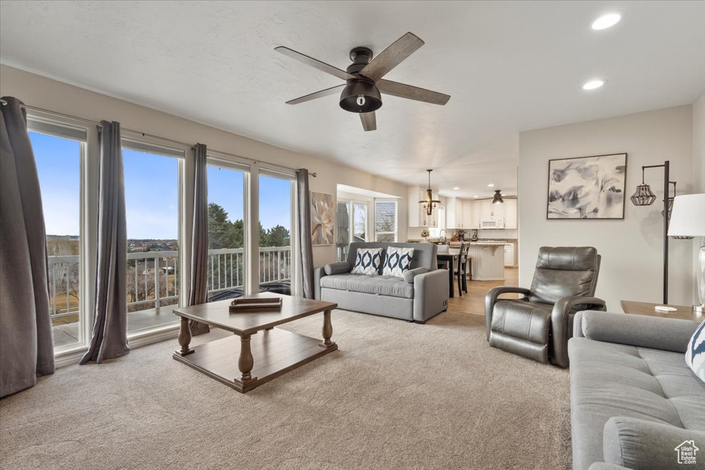 Living room featuring carpet, a ceiling fan, and recessed lighting