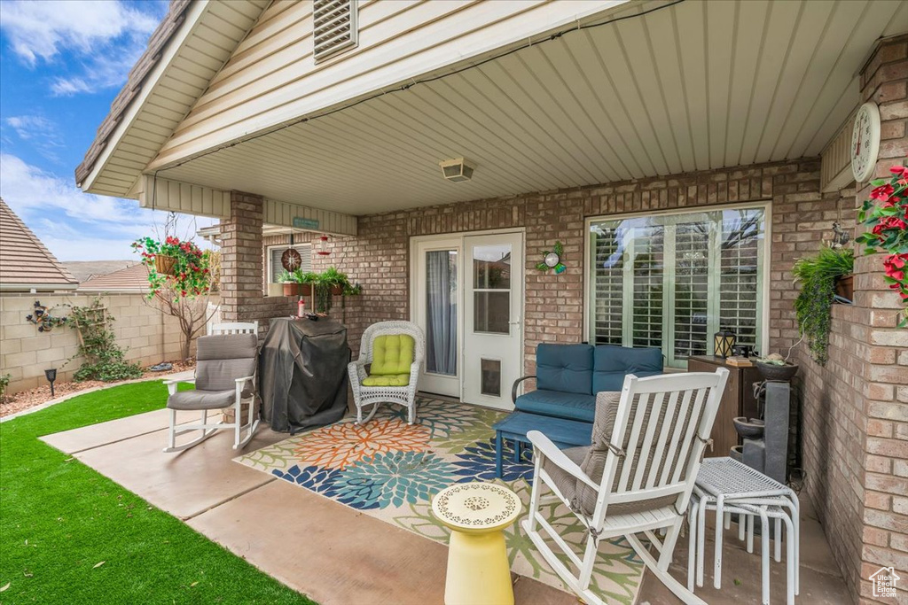 View of patio featuring grilling area and an outdoor hangout area