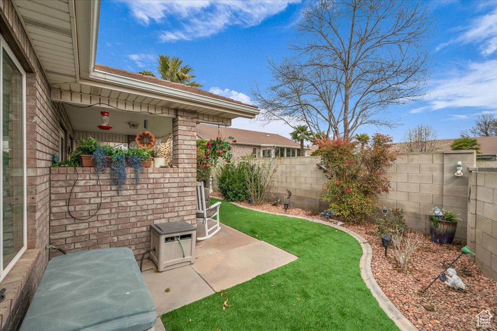 View of yard featuring a fenced backyard and a patio