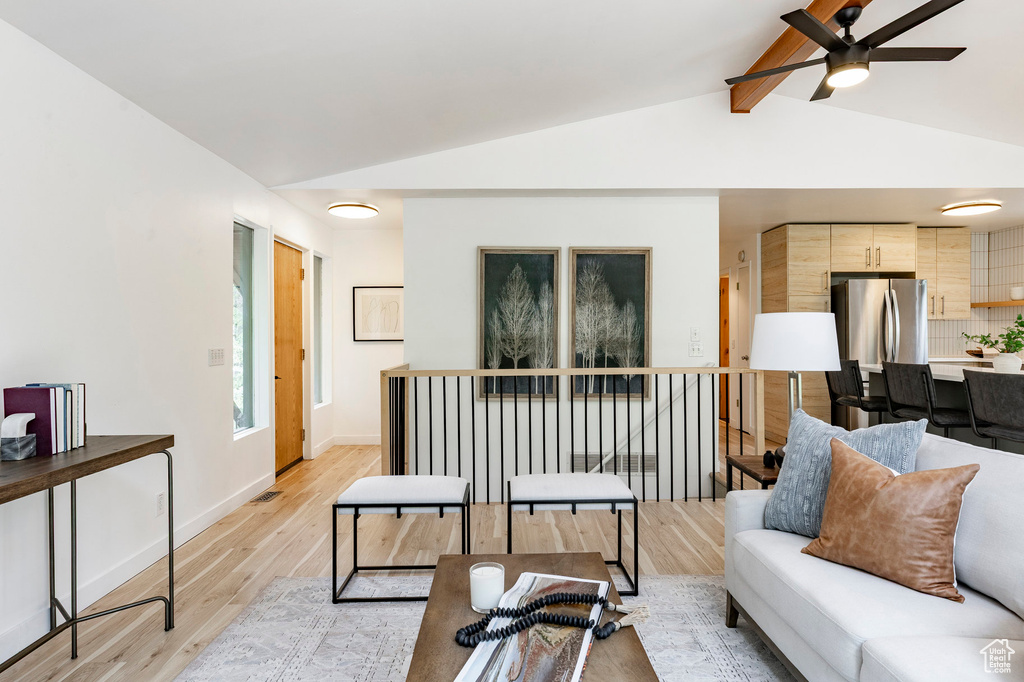 Living area with light wood finished floors, ceiling fan, and baseboards