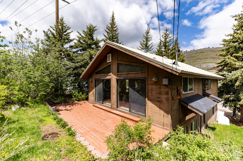 Rear view of property featuring a wooden deck