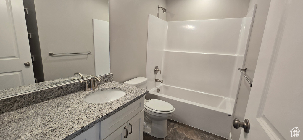 Bathroom featuring toilet, vanity, and shower / bathtub combination