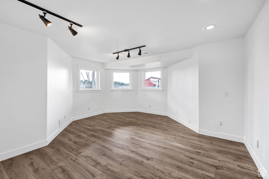 Unfurnished room featuring baseboards, wood finished floors, and recessed lighting