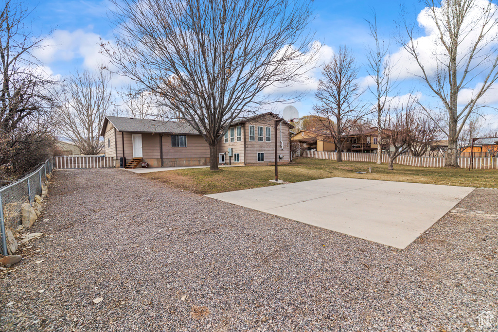Exterior space with driveway and a fenced backyard