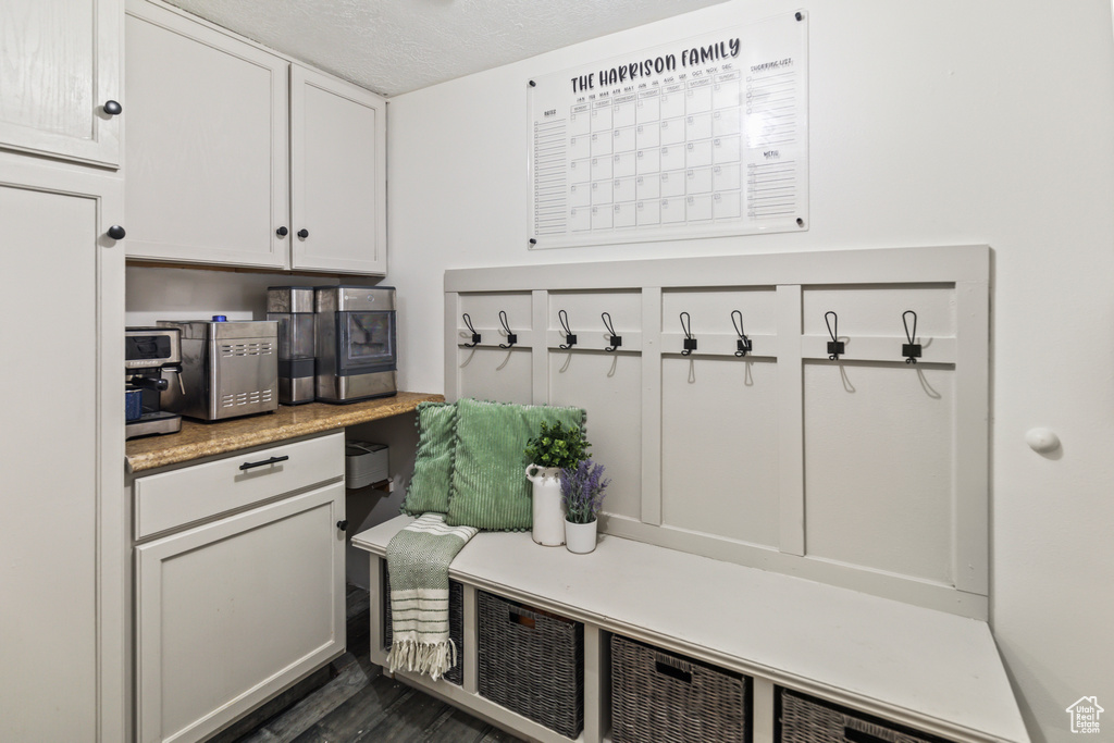Mudroom with a textured ceiling