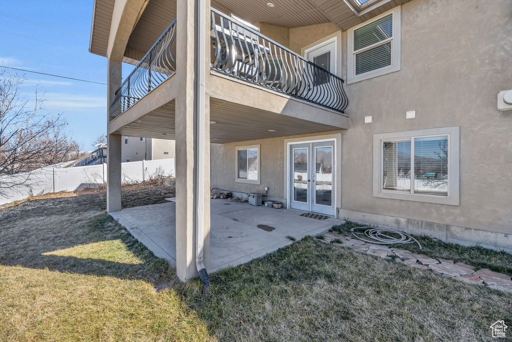 View of patio / terrace with french doors, fence, and a balcony