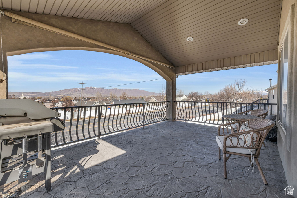 View of patio with a mountain view, area for grilling, and a balcony