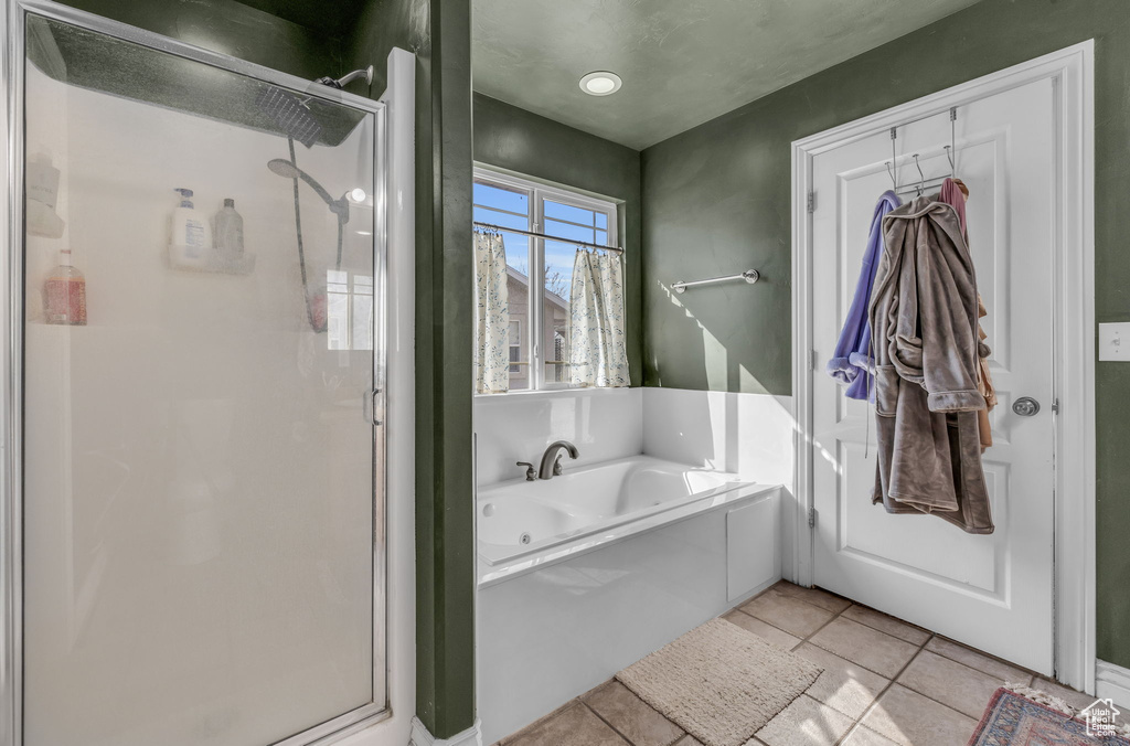 Full bath with tile patterned flooring, a shower stall, and a bath