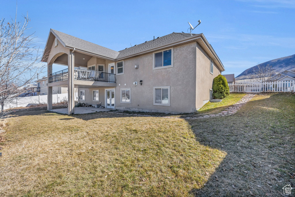 Back of property with a patio, roof with shingles, fence, a yard, and stucco siding