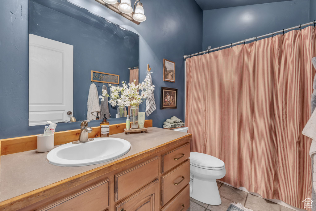 Bathroom with tile patterned flooring, vanity, and toilet