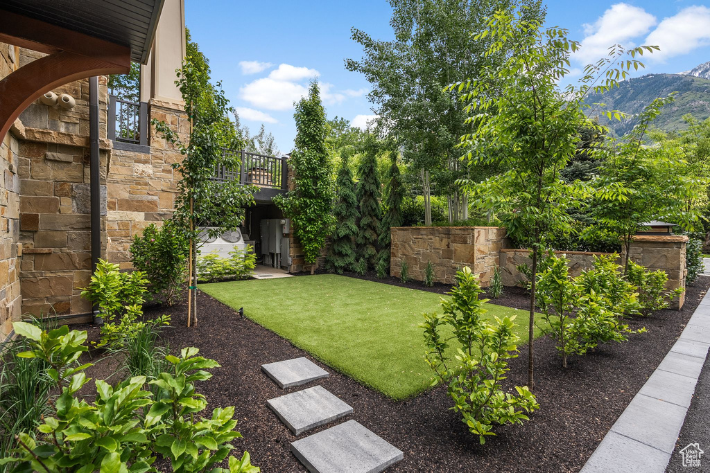 View of grassy yard with a mountain view