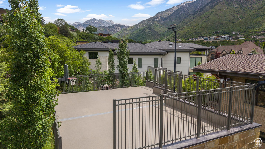 Back of house featuring a mountain view, driveway, and a patio area
