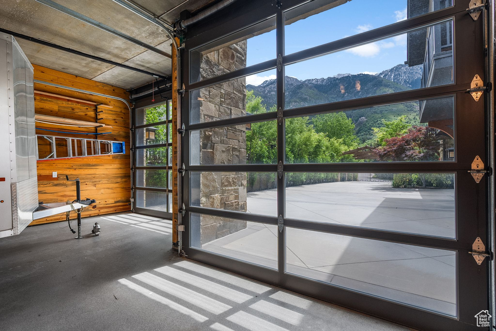 Garage featuring a mountain view and wooden walls