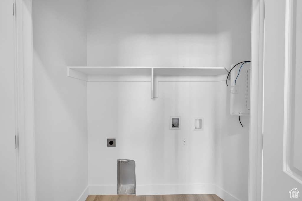 Laundry room with washer hookup, laundry area, electric dryer hookup, and wood finished floors