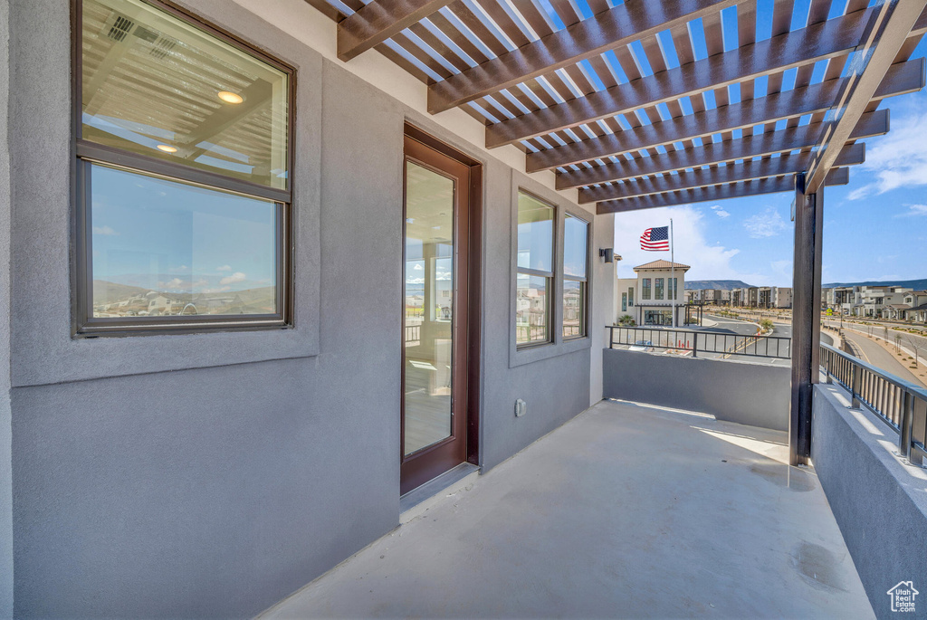 Balcony with a sunroom and a pergola