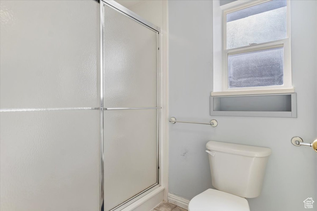 Bathroom with toilet and an enclosed shower