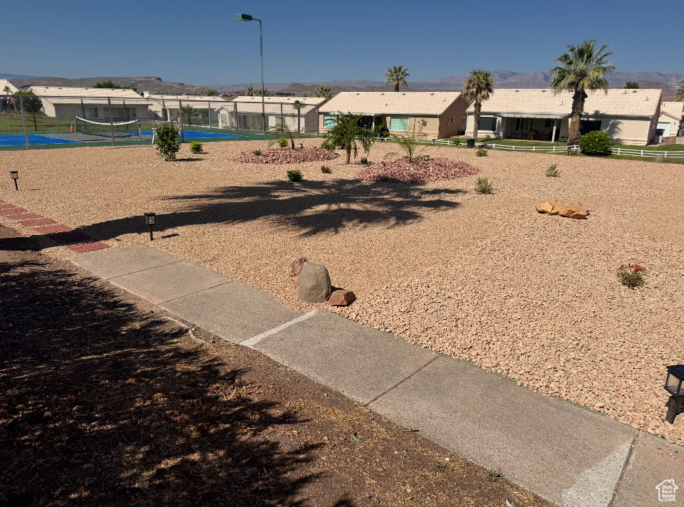 View of yard with volleyball court and a residential view