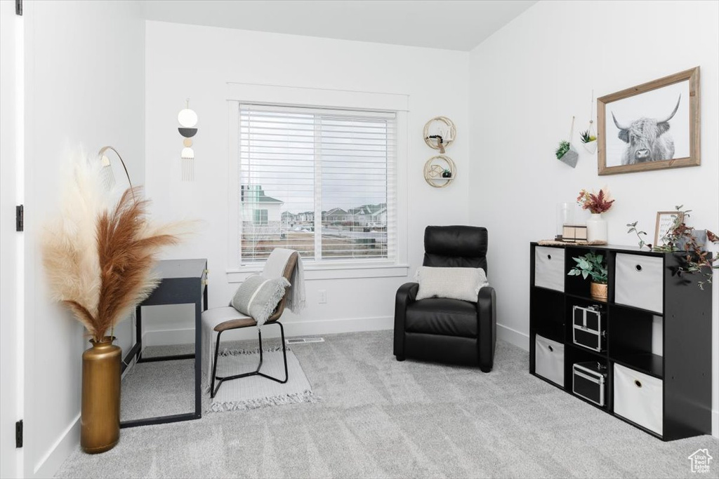 Living area featuring carpet floors and baseboards