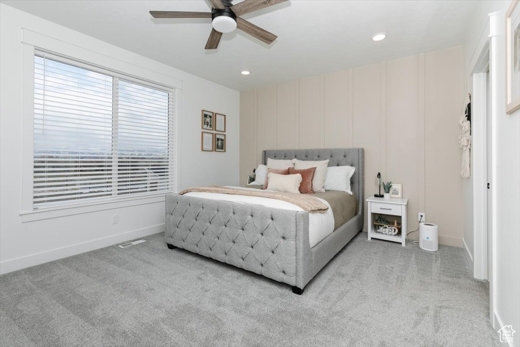 Carpeted bedroom with baseboards, visible vents, ceiling fan, and recessed lighting